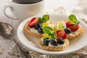 Small berry cakes on white background