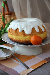 Easter cake on a plate and painted eggs on the table..