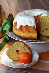 Easter cake, cut into pieces on a plate and painted eggs on the table..