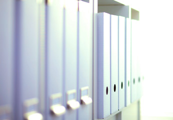 Obraz premium File folders, standing on shelves in the background