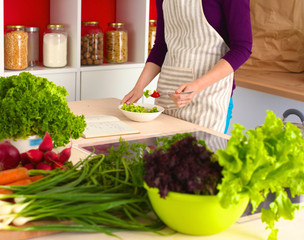 Young Woman Cooking in the kitchen. Healthy Food