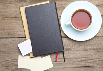 Blank business cards with pen and tea cup on wooden office table