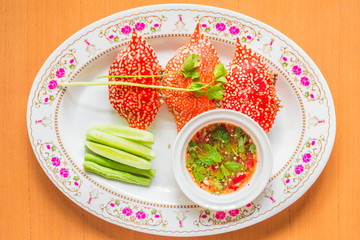 Stuffed crab and a cup of sauce