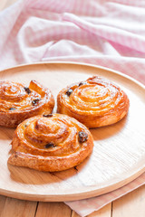 Obraz na płótnie Canvas Cinnamon and raisin roll bun,still life style from above.