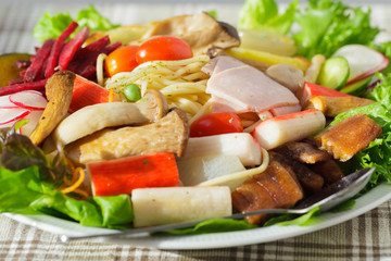 Salads line spaghetti.