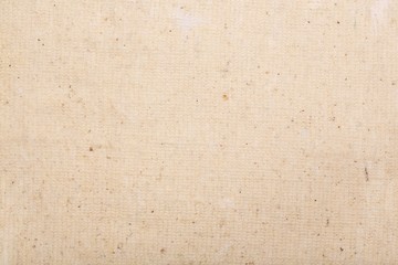 A pice of beige fabric. Closeup