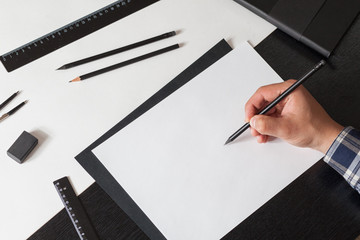 Man draws a sketch on the table