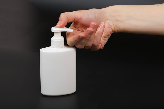 Liquid soap dispenser and a human hand