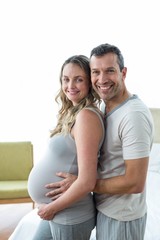 Man holding pregnant womans stomach