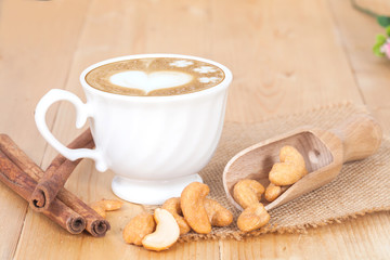 Cashew nuts in spoon, on the wooden