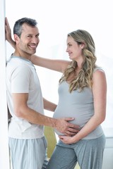 Man holding pregnant womans stomach