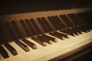 Closeup of piano keys and wood grain with sepia