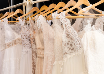 wedding dresses hanging on racks