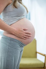 Pregnant woman holding her stomach