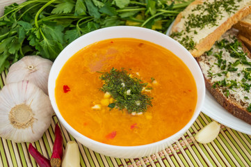 Traditional oriental soup with tomatoes, red lentils, green