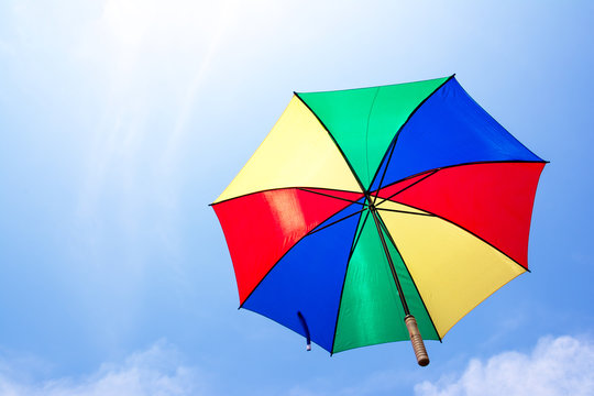 Colorful umbrella with beautiful blue sky