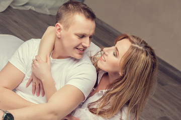 Happy couple in a bedroom.