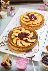 Two cakes with fruit on a buffet table