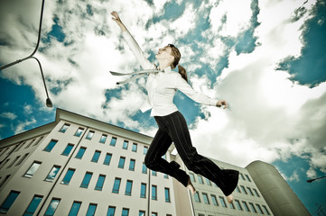 businesswoman flying in a urban landscape reaching the sky