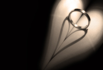 heart shadow with rings on a book middle write your text in blac