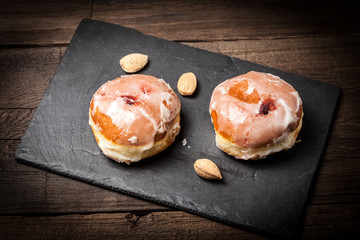 Donut with icing and rose jam.