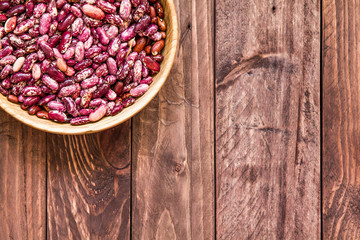 Raw beans in a wooden plate and 