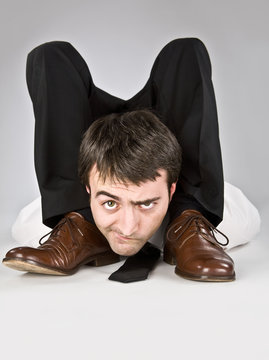 flexible businessman with doubtful face isolated on white