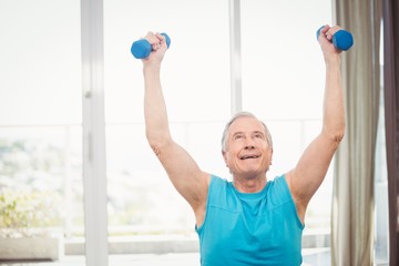 Senior man holding dumbbells