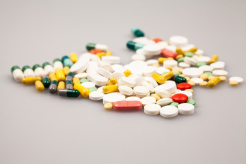 Composition with colorful pills and light grey background
