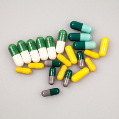 Composition with colorful pills and light grey background