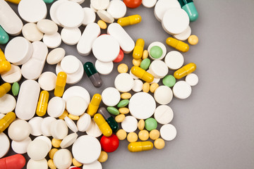 Composition with colorful pills and light grey background