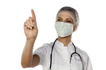 a young woman doctor touches empty screen