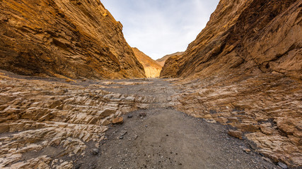 Hiking trail through the narrows at Mosaic Canyon. The canyon narrows dramatically to a deep slot cut. Mosaic Canyon, Death Valley National Park, California