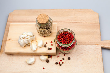 Garlic and spices on wooden kitchen board