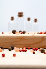 Spices and empty, small glass bottles with wooden texture