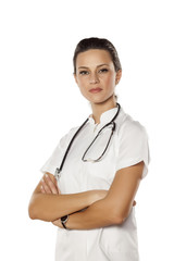 pretty young woman doctor posing on a white background