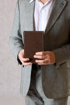 A book in a man's hands. Closeup