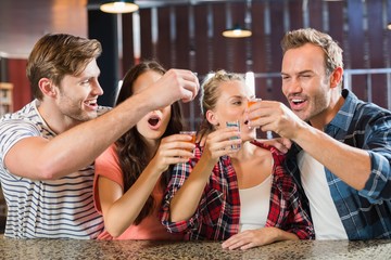 Friends toasting with shots