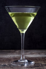 Green apple cocktail on black stone background
