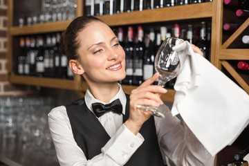 Barmaid cleaning a glass