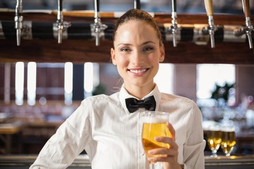 Barmaid holding a beer