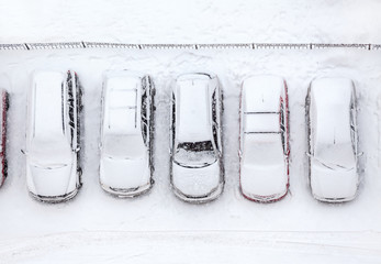 Car standing at winter parking lot covering with snow, top view © Kekyalyaynen