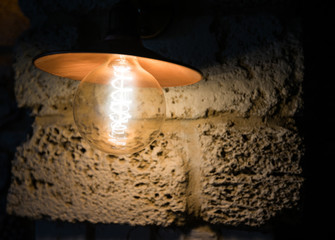 Light bulb on stone surface