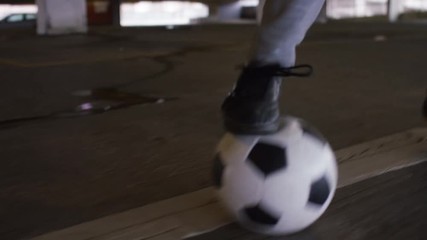 Feet of a skillful soccer player doing quick movements with his football