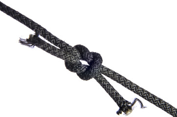 Reef knot made of black rope on a white background