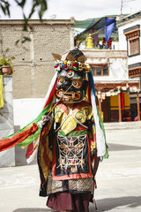 Fototapeta na wymiar An unidentified buddhist lamas dressed in mystical mask dancing Tsam mystery dance in time of Yuru Kabgyat Buddhist festival at Lamayuru Gompa