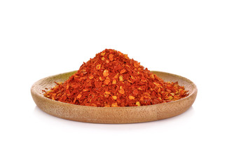 Red Chili Pepper powder in wooden plate on white background