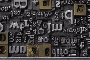 Metal Letterpress Types.
A background from many historic typographical letters in black and white with white background.

