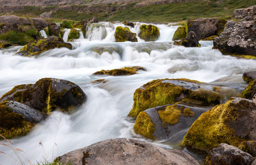 Naklejka na ściany i meble Landscape with small waterfall, part of Dynjandi waterfall, long exposure, Iceland