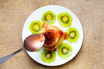 Pancakes with strawberry cream and kiwi fruit